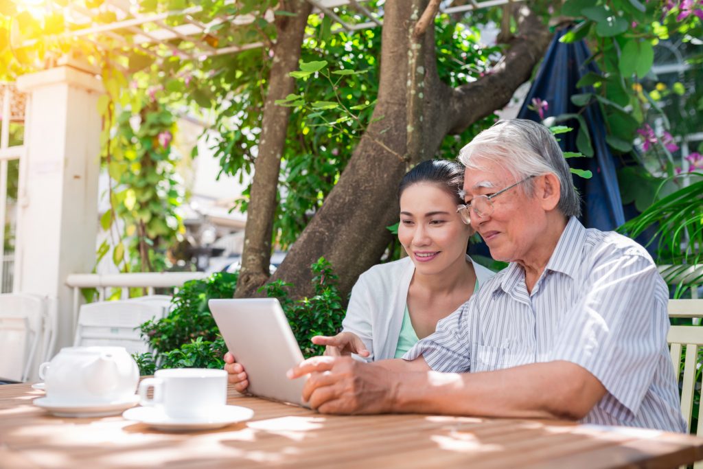 daughter and father on laptop