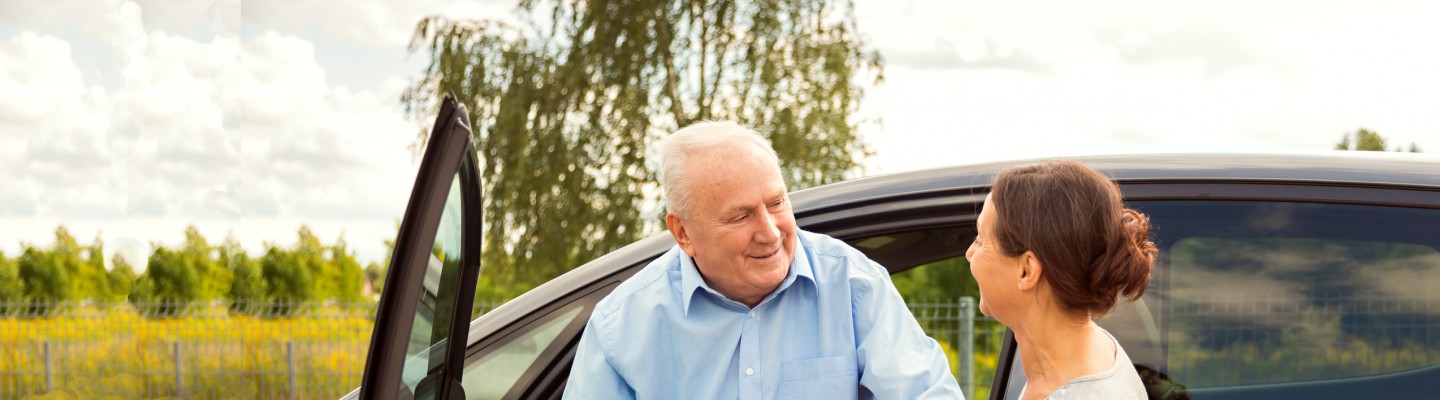 elderly man with carer out driving
